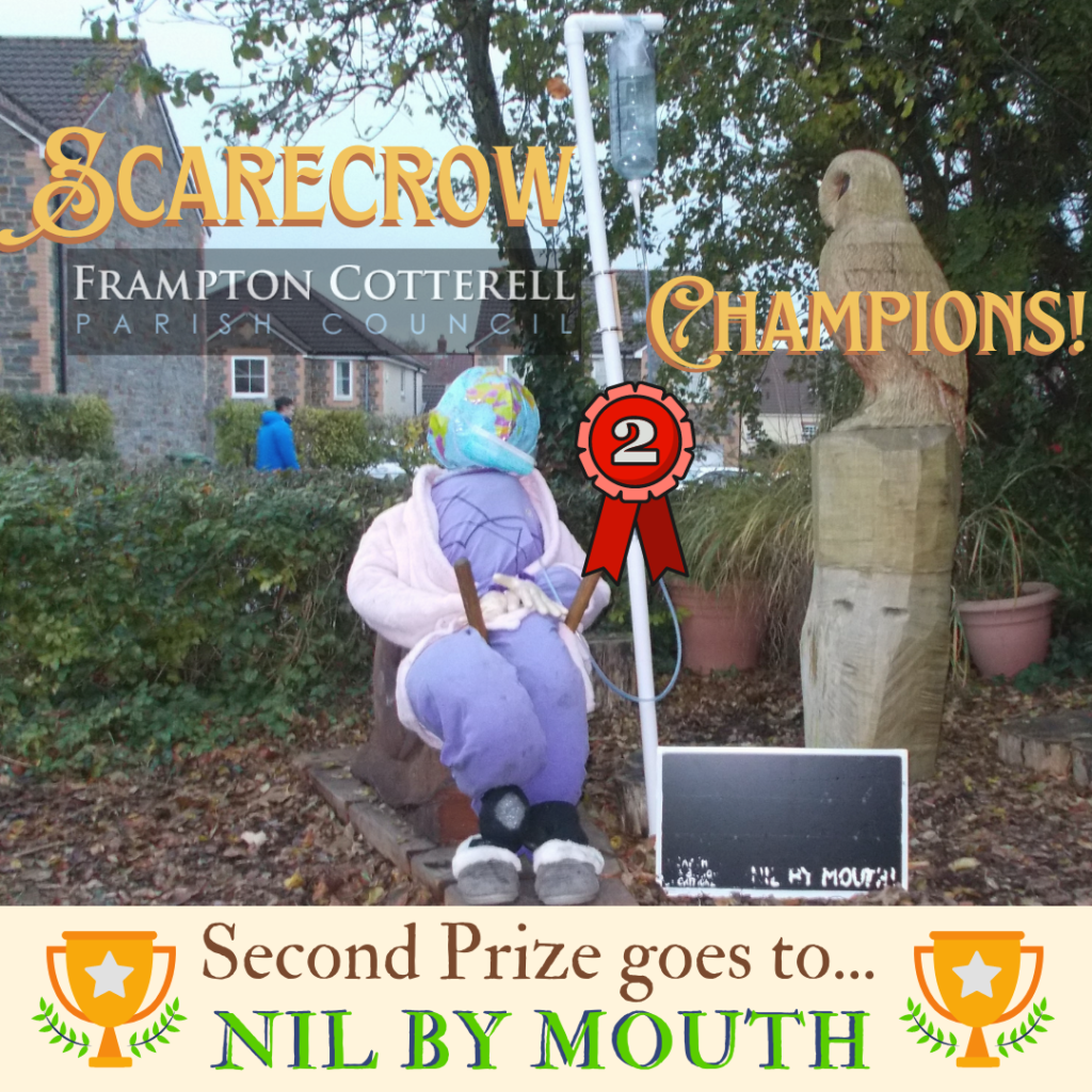 An image of a scarecrow hooked up to an IV drip, and ‎text which reads, "‎SCARECROW CHAMPIONS! Frampton Cotterell Parish Council. Second Prize goes to... NIL BY MOUTH‎"‎‎ 