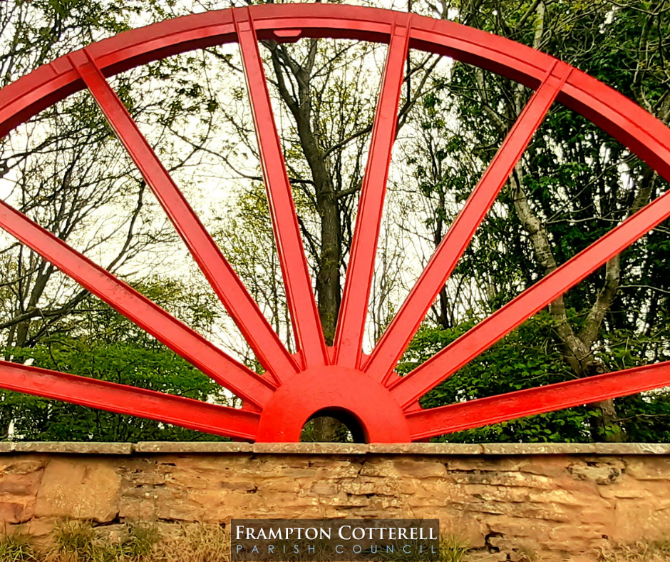 Photograph of Centenary Wheel. It is now clean, not rusty, and a very bright red.