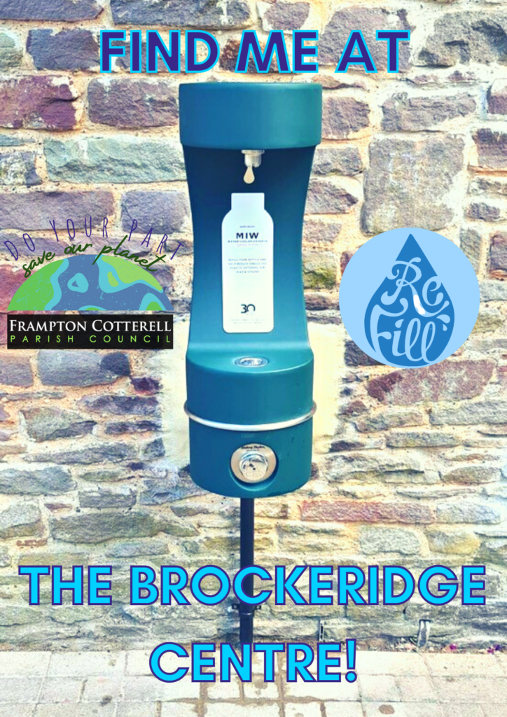 A photograph of the new water founatain. The fountain is dark green and is mounted on a black pole in front of a light, natural brick wall. Text above and below reads FIND ME AT THE BROCKERIDGE CENTRE. A logo to the left says "Do Your Part, Save Our Planet" and shows a semicircle of the earth above a black rectangle with the text Frampton Cotterell Parish Council. To the left is the Refill logo, a mid-blue water droplet with the word Refill in calligraphic font inside. 