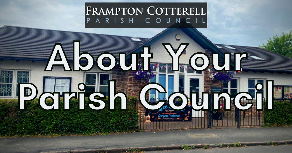 Frampton Cotterell Parish Council [logo text]. About Your Parish Council. Text over photo of a single-storey white building with a grey tiled roof, large windows, floral hanging baskets, a green hedge, and railings with a banner attached.