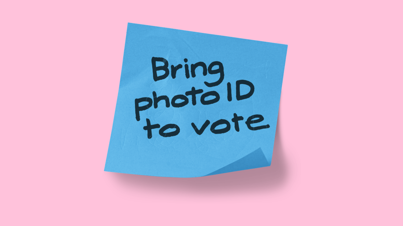 A blue post it note on a pink background. Text reads "Bring photo ID to vote"